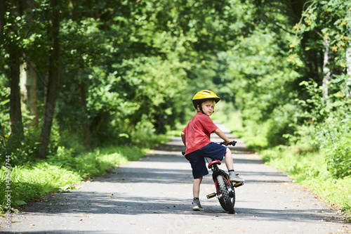 Wallpaper Mural Young boy riding bicycle on a summer day at asphalt road. Bicycle path Torontodigital.ca