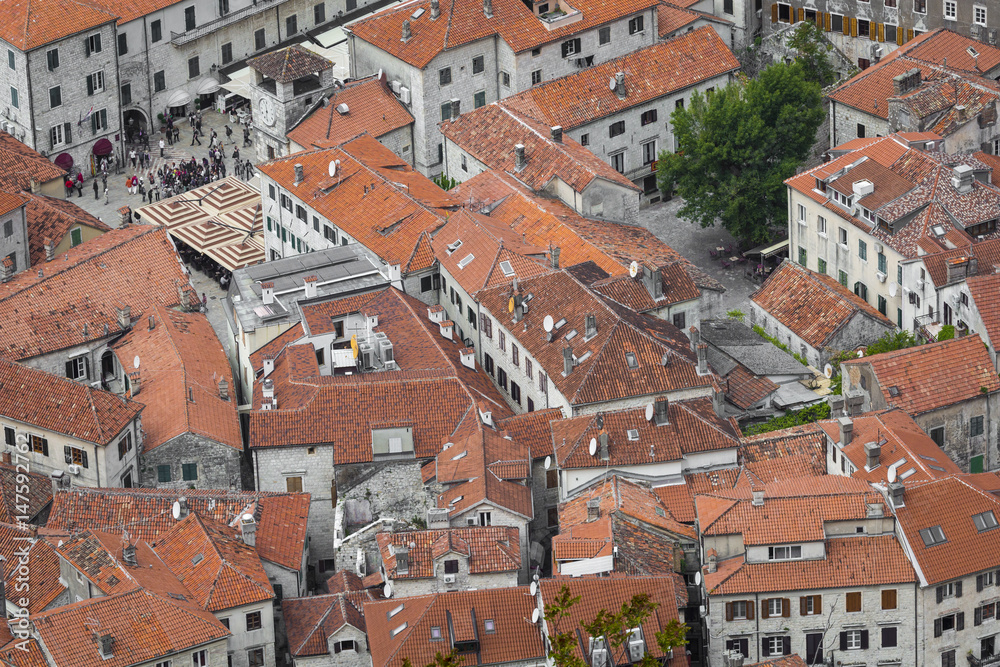 Bright tiled roofs of the houses in Kotor old town in Montenegro seen from above
