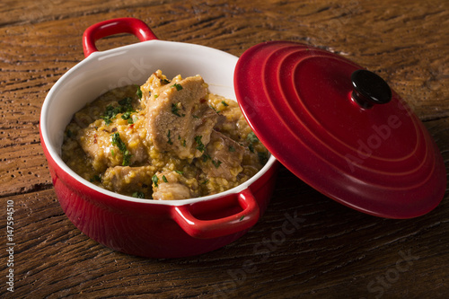 Brazilian dish canjiquinha or pela egua in red bowl. photo