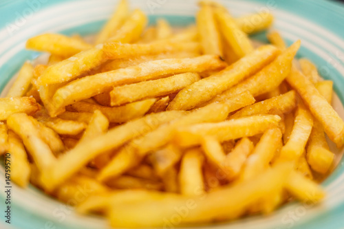 Closeup of frech fries on ceramic dish