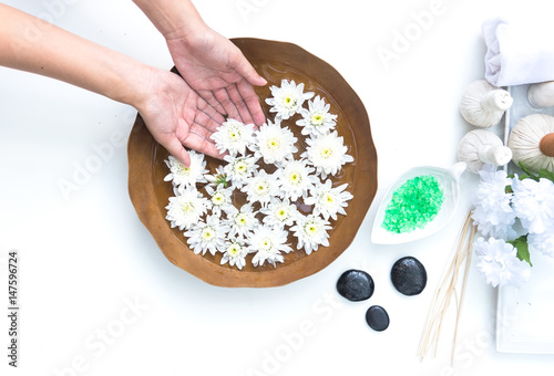 Spa treatment and product for hand and foot spa with flowers and water  wooden background 