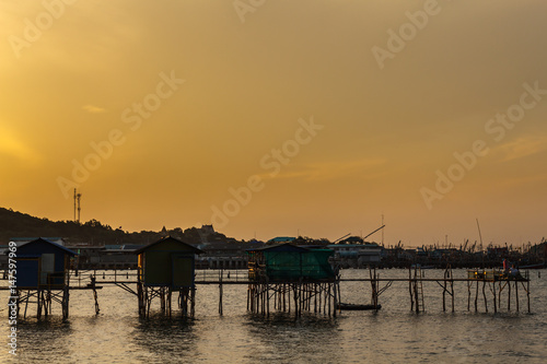 wooden pier bridge with sunrise yellow sky in the morning time