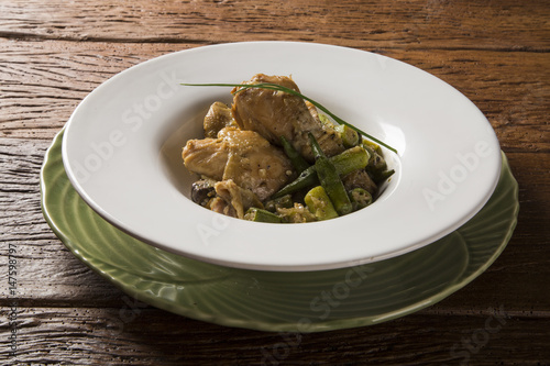 Frango com quiabo (Portuguese for "chicken with okra"), Brazilian dish in white plate.