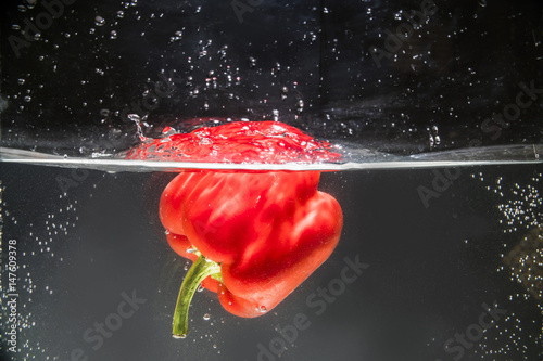 red bell pepper splashing in water