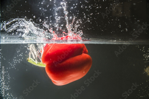 red bell pepper splashing in water