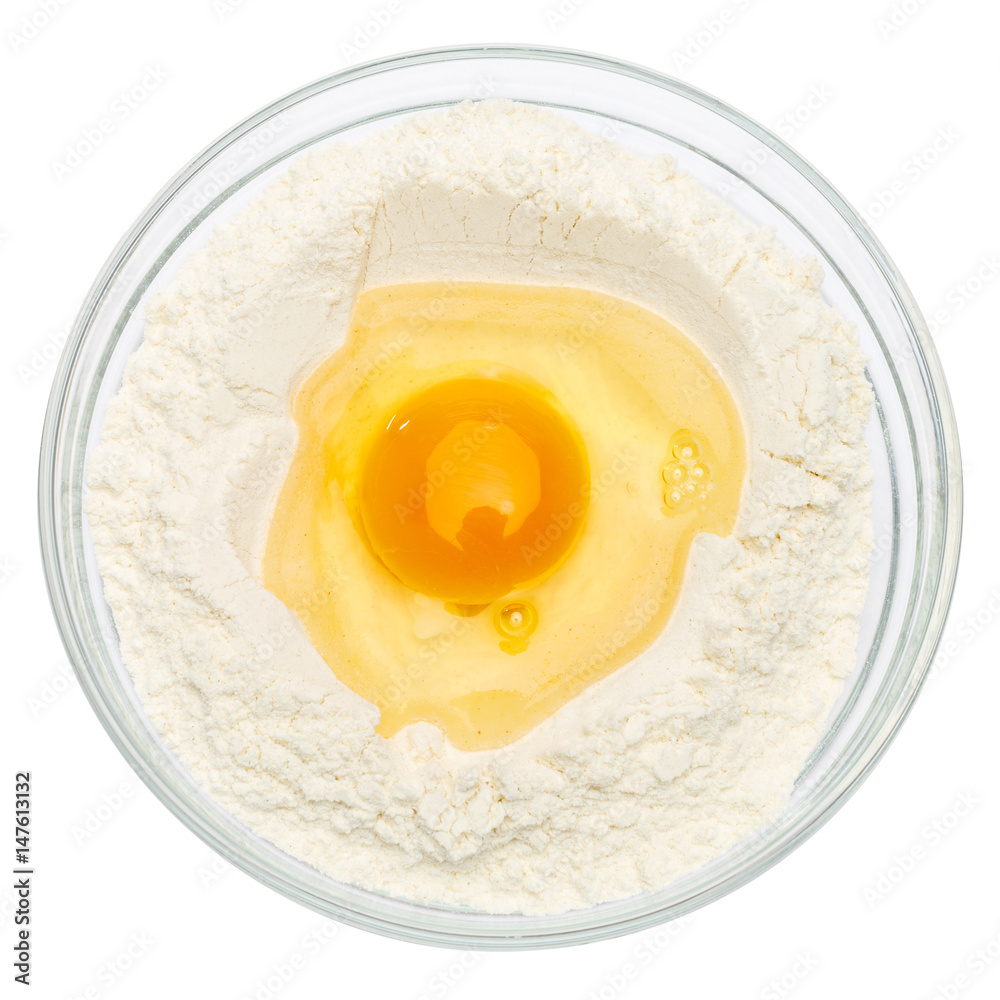 Flour with egg in glass bowl