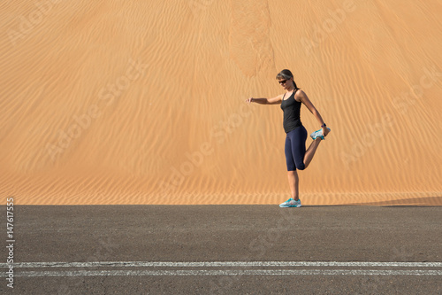 Woman exercising in the desert. © Kertu