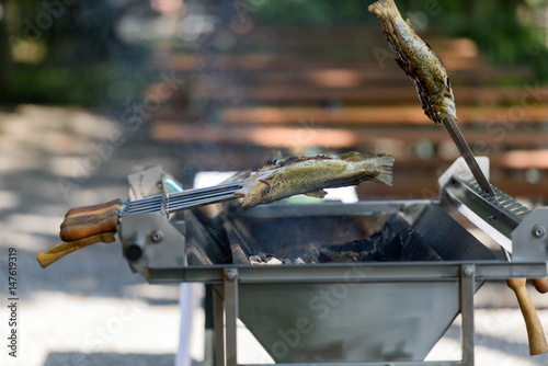 Fotografie Fish in heat - German Steckerlfisch on the grill