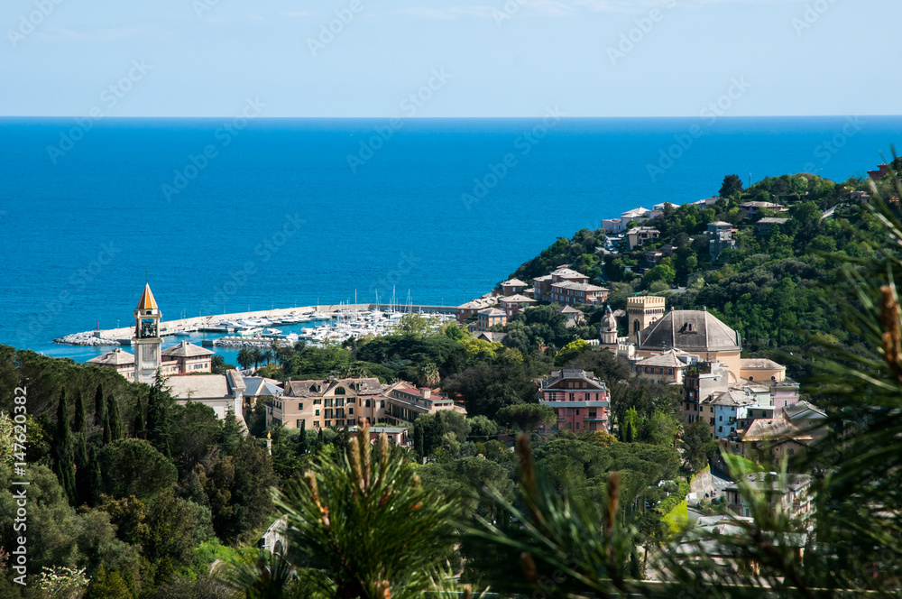 Fototapeta premium panorama of small town Arenzano in Liguria with its harbor and famous church 'Gesù Bambino di Praga' in the background