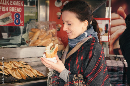 Canvas Print Tourist woman enjoy traditional turkish street food in Istanbul