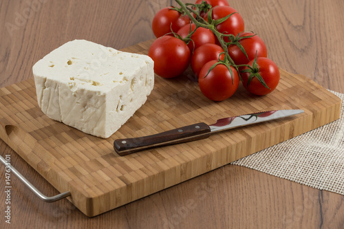 organic cheese and tomatoes on wooden table