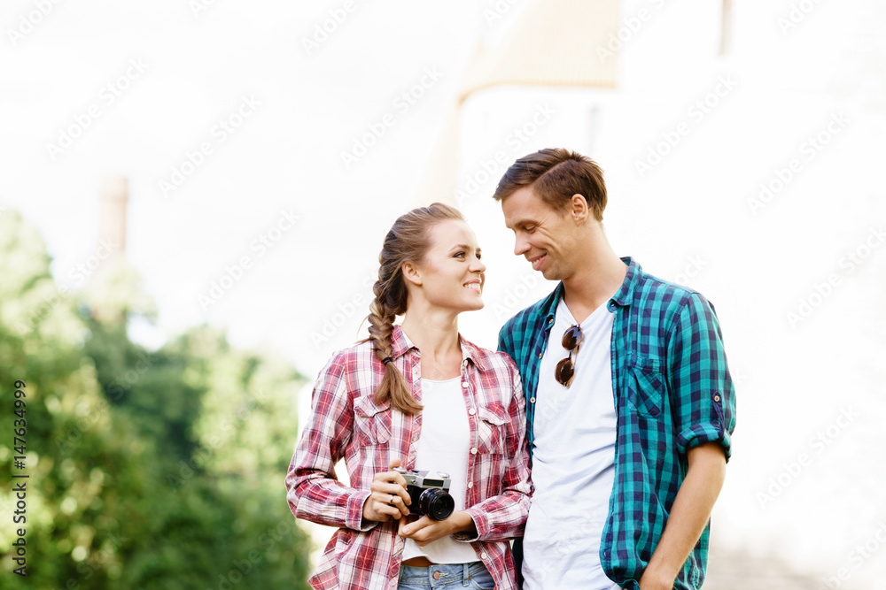 Young traveling couple: taking pictures of old town. Vacation, summer, holiday, journey: concept. Young traveling couple: taking pictures of old town. Vacation, summer, holiday, journey: concept.