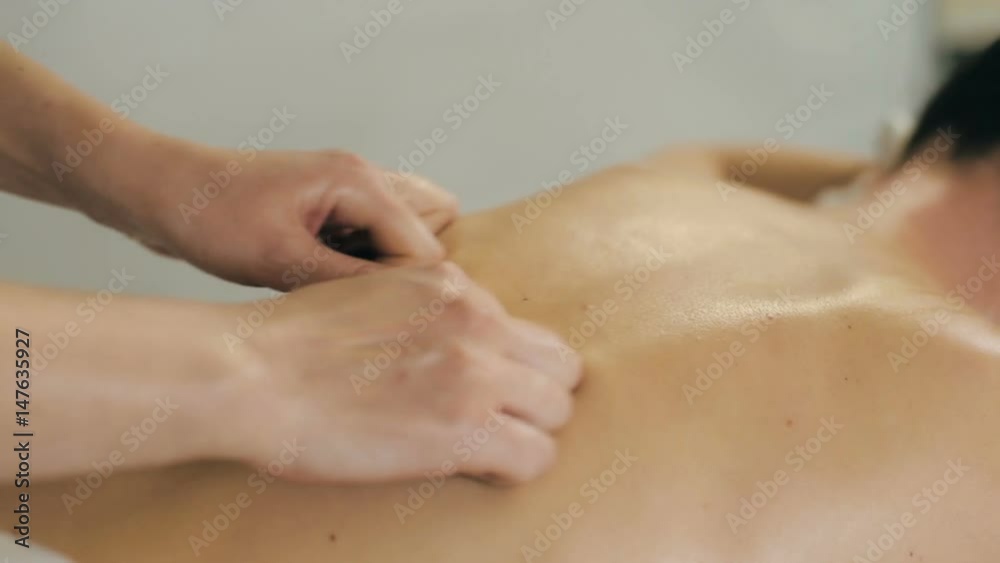 Masseur doing massage to woman Masseur doing massage to woman