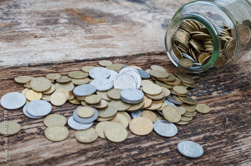 Ukrainian coins in a jar on a wooden background