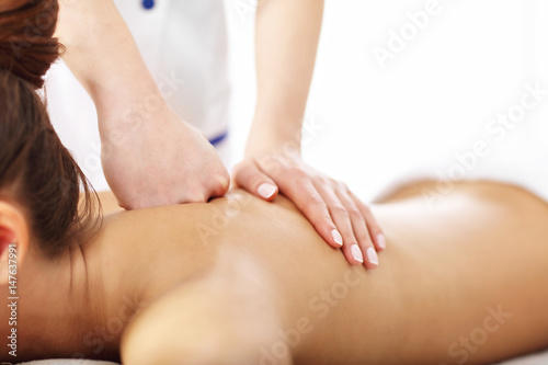 Beautiful woman getting massage in spa