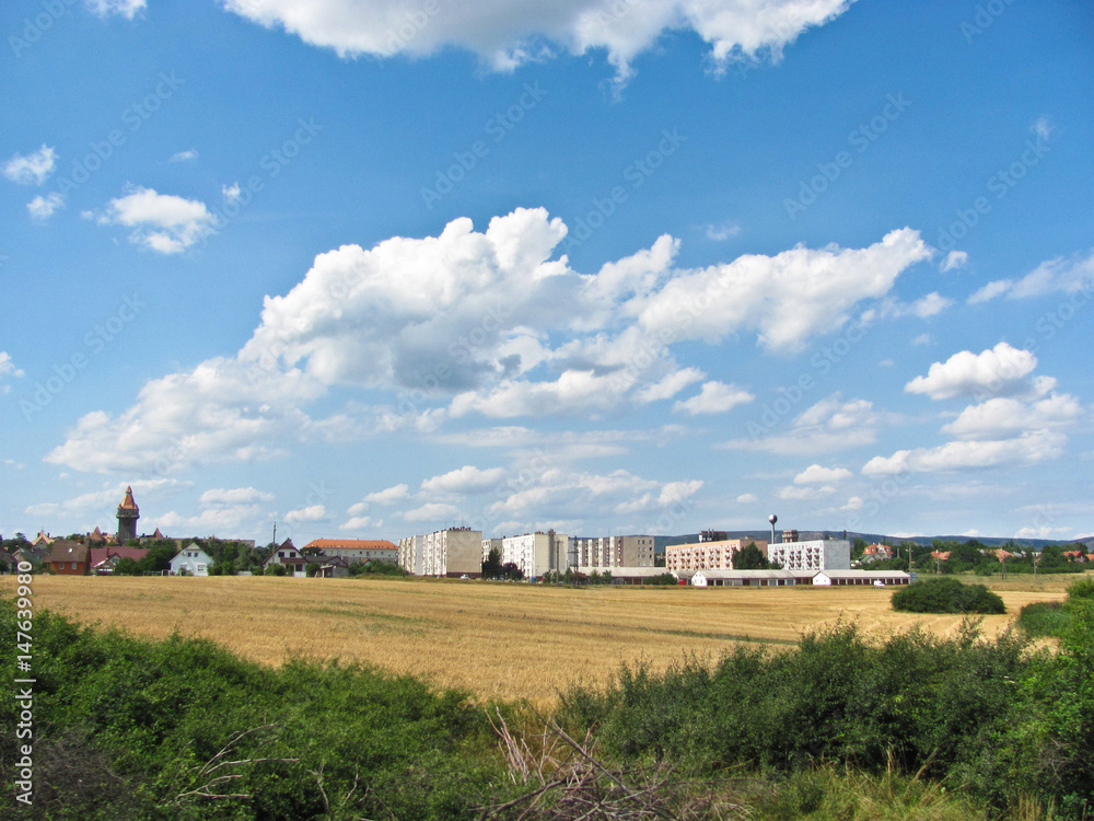 View of the small city from window of train. View of the small city from window of train.
