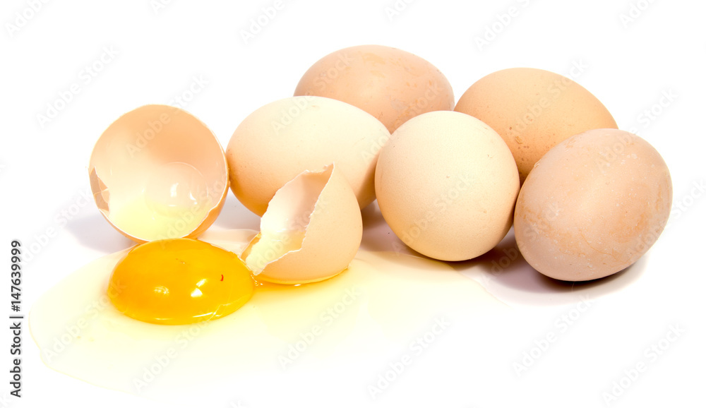 Broken egg in eggshell half and raw egg isolated on white background cutout Broken egg in eggshell half and raw egg isolated on white background cutout