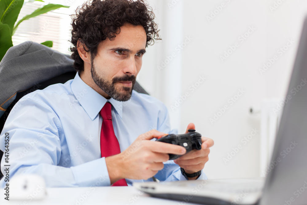 Businessman playing videogames in his office