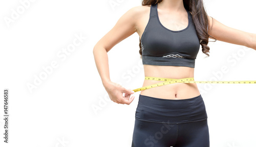 Sport Young Woman in Sportswear Measuring Her Waist by Measure Tape on White Background - Weight Loss and Health Care Concept