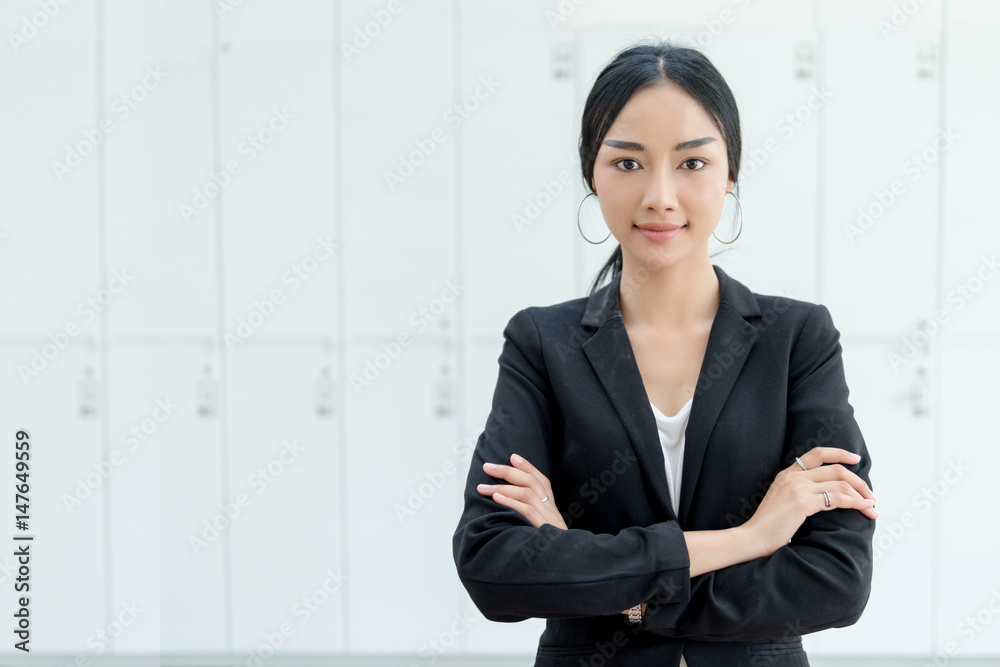 Businesswoman cross one's arm,Professional woman is smiling in black suite.