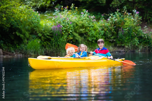 Kids kayaking on a river