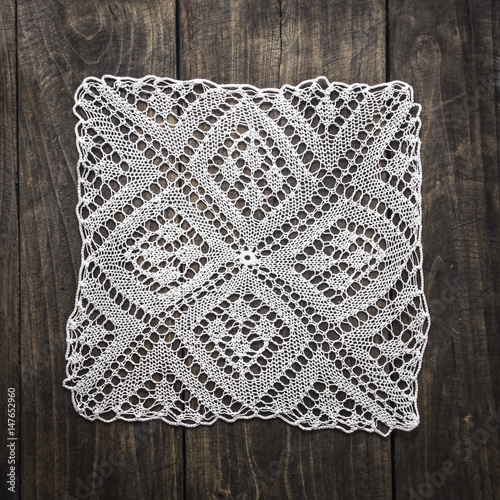 Crocheted Doily on wooden table