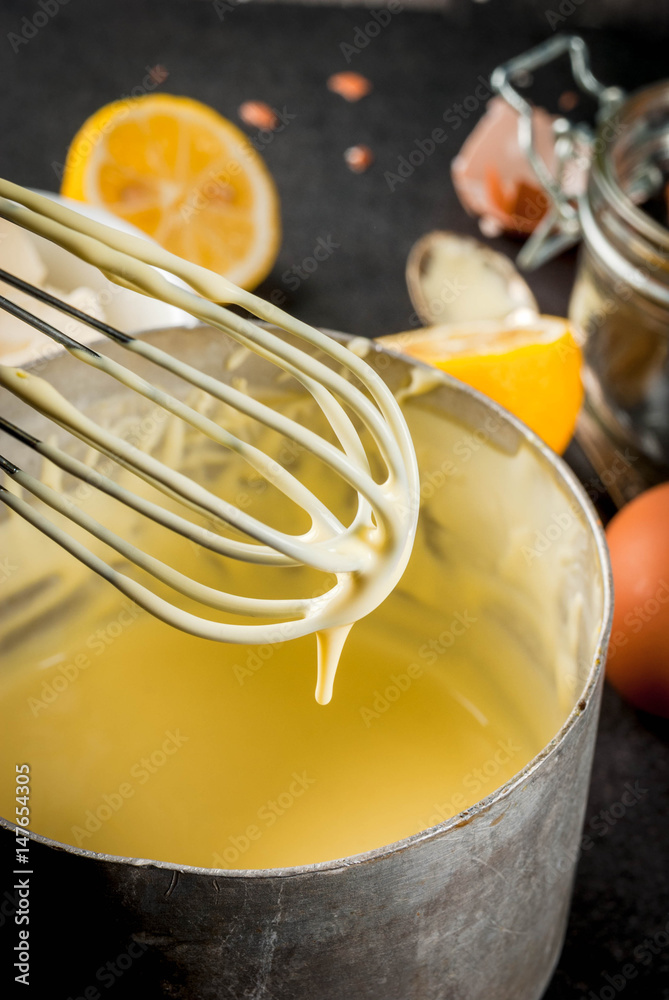 Traditional basic sauces. French cuisine. Hollandaise sauce in a metal