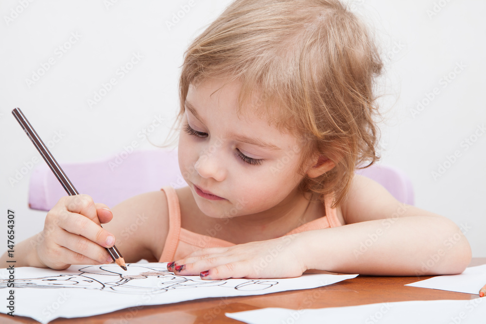 Little girl drawing with colored pencils on paper Little girl drawing with colored pencils on paper