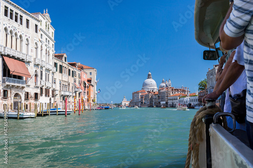 View of the Grand Canal in Venice. View of Basilica Santa Maria della Salute . Passengers, tourists swim on a vaporetto on a grand canal. The symbol of Venice,Italy photo