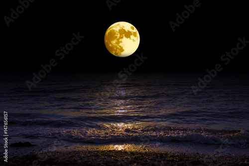 Landscape moon over horizon on sea and moonlight.  Panorama with the luna of night. Grand mystical fantastic view.