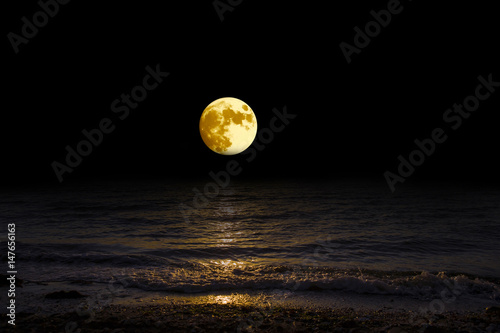 Panorama moon over the horizon on sea and moonlight. Landscape with the luna of night. Grand mystical fantastic view.