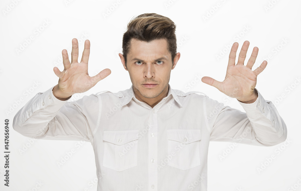 Handsome young man making furious face, with hands on head, isolated on white Handsome young man making furious face, with hands on head, isolated on white