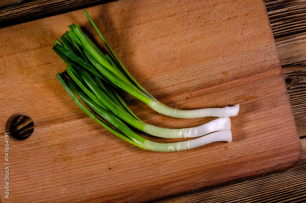Green onion on cutting board. Top view Green onion on cutting board. Top view