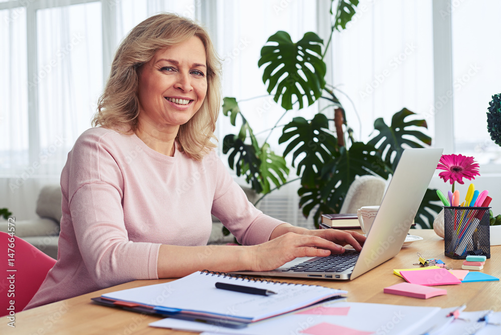 Woman with sunshine smile working in laptop Woman with sunshine smile working in laptop