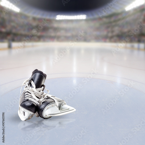 Hockey Skates on Ice of Crowded Arena