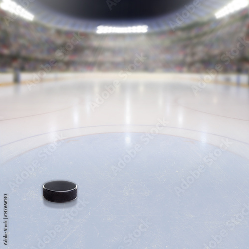 Photography Hockey Puck on Ice of Crowded Arena