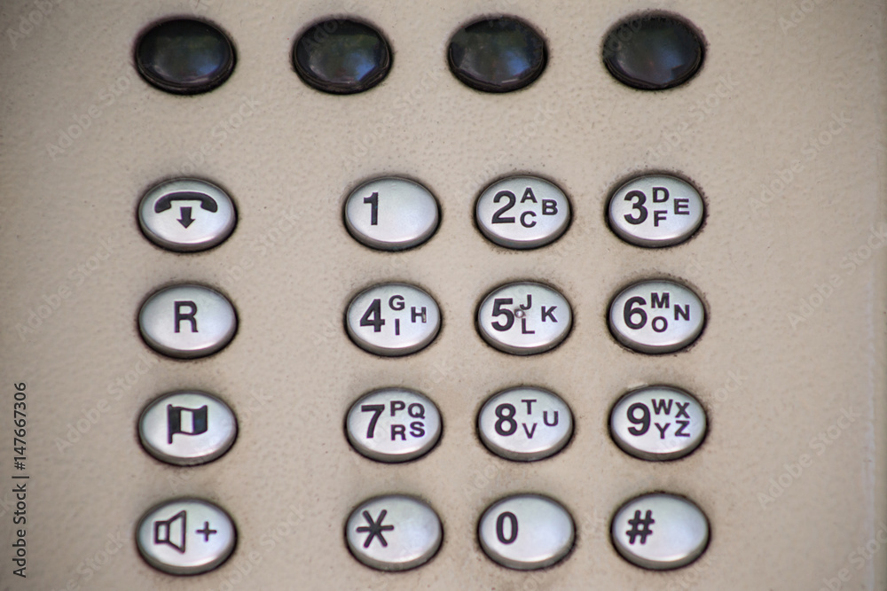 Telephone booth in the street. Phone buttons close up Telephone booth in the street. Phone buttons close up