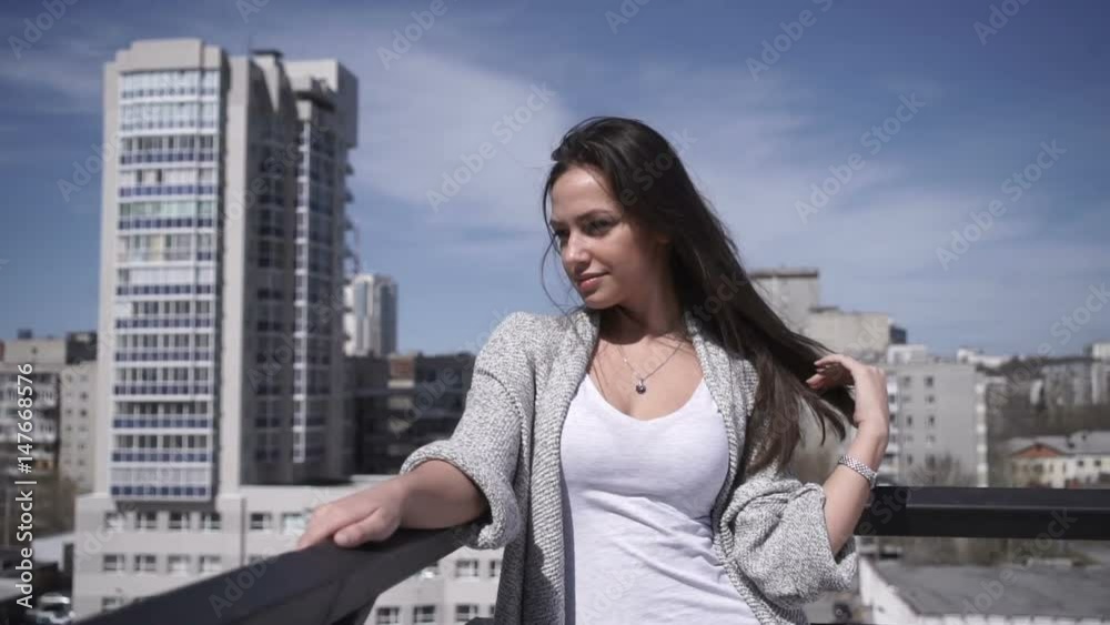 Woman adjusting hair at handrail Woman adjusting hair at handrail