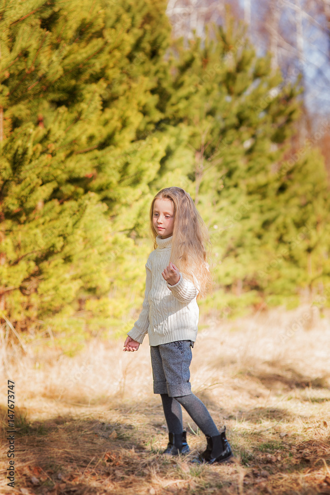 Cute beautiful girl with long flowing hair in a spring forest Cute beautiful girl with long flowing hair in a spring forest