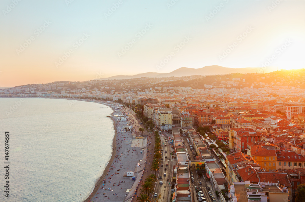 cityscape of Nice with beach and sea at sunset, French Riviera, France