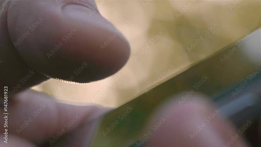 Closeup of young man hands typing sms scrolling pictures phone Closeup of young man hands typing sms scrolling pictures phone
