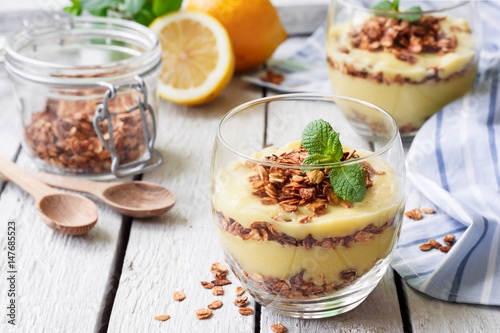 Healthy dessert in a glass with lemon cream and granola