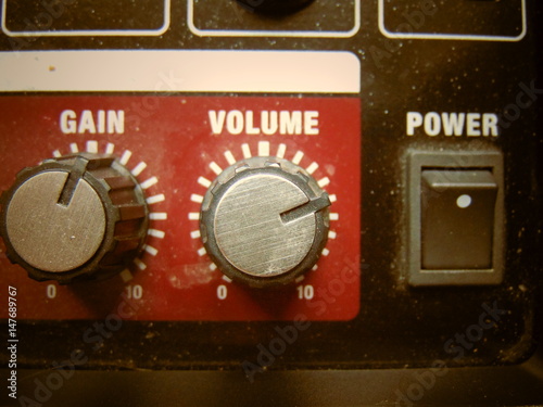Volume knob close up sepia background