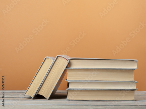 Stack of books on the wooden table. Education background. Back to school. Copy space for text.
