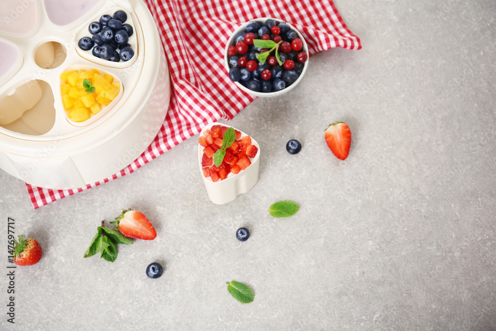 Composition with tasty yogurt and ingredients on kitchen table Composition with tasty yogurt and ingredients on kitchen table