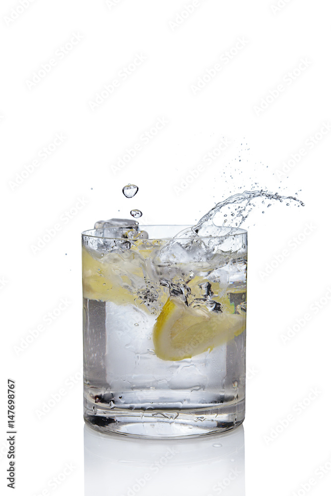 Ice cube and lemon splashing cocktail in oldfashioned glass. Drink with splashing citrus isolated on white. Ice cube and lemon splashing cocktail in oldfashioned glass. Drink with splashing citrus isolated on white.