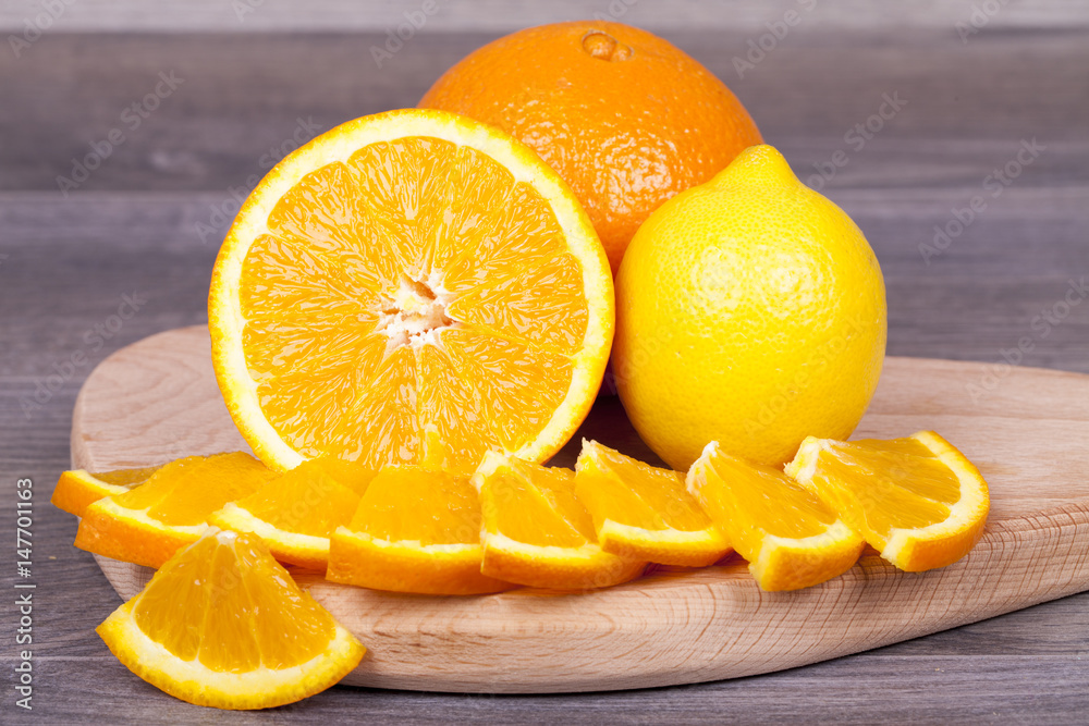Fresh and juicy orange cut into pieces and lemon Fresh and juicy orange cut into pieces and lemon