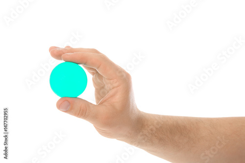 Male hand with stress ball on white background