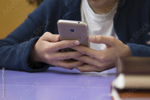 close-up of hands of the child with the mobile phone