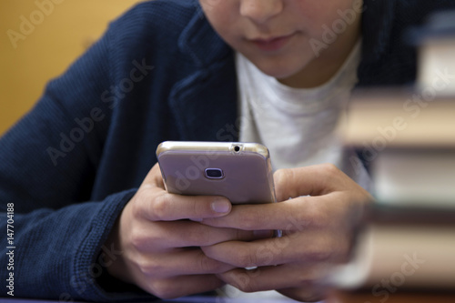 close-up of hands of the child with the mobile phone